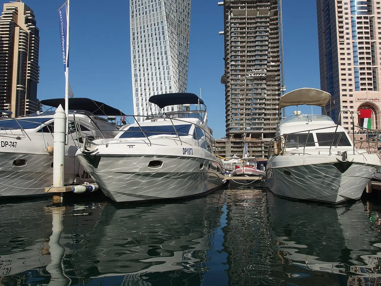 Luxury yachts moored in Dubai Marina beneath the towers