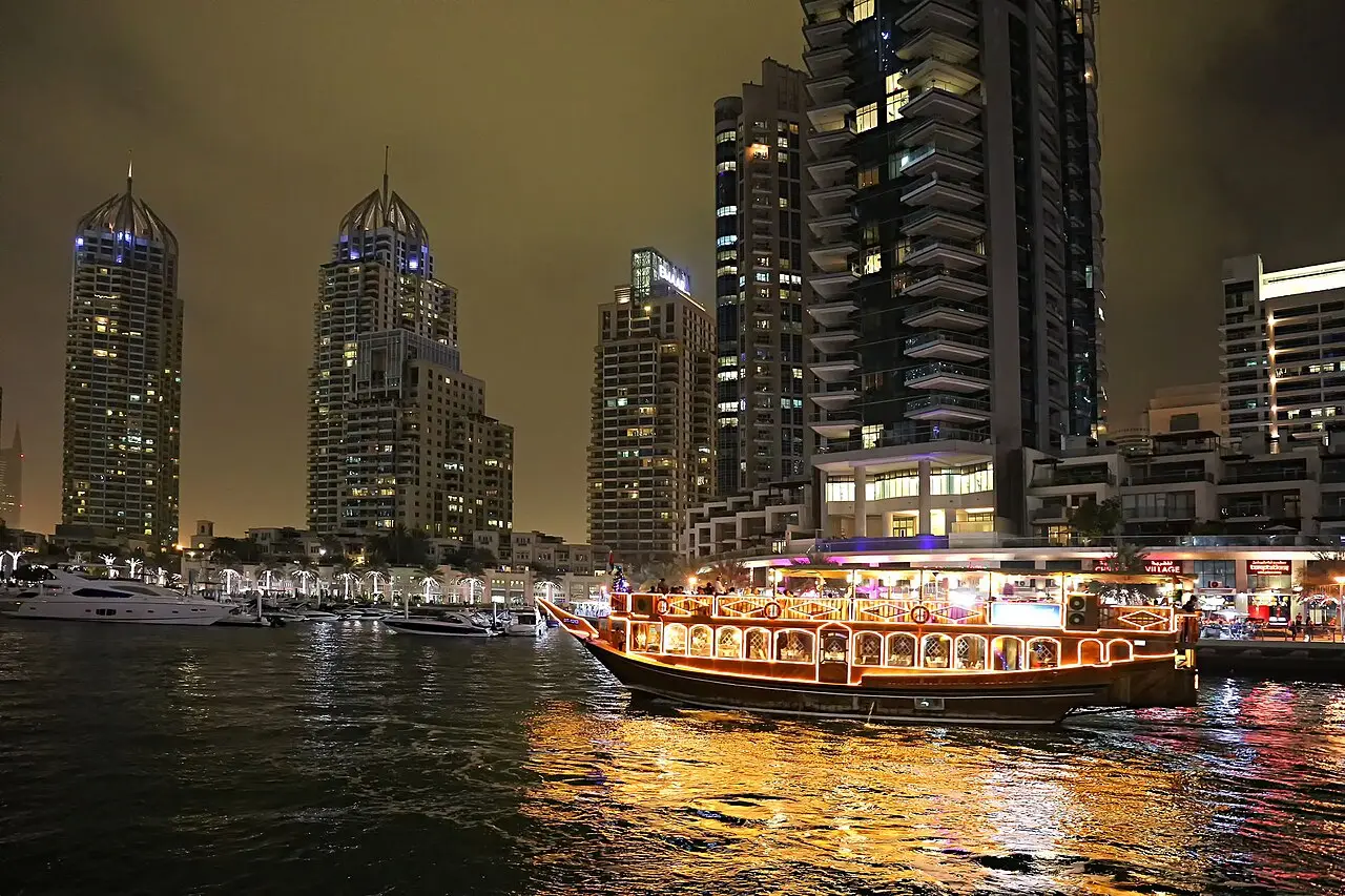 Dubai Marina's towers reflected in the water at night