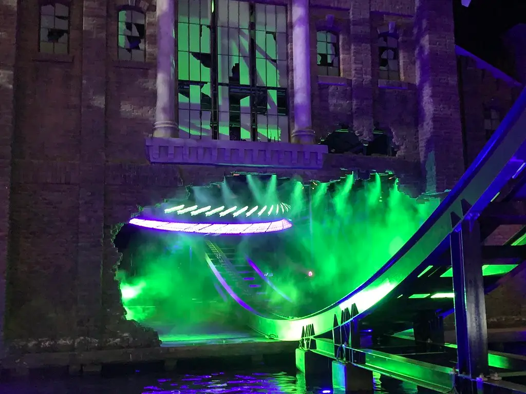 A ride lit up in green inside Warner Bros. World Abu Dhabi