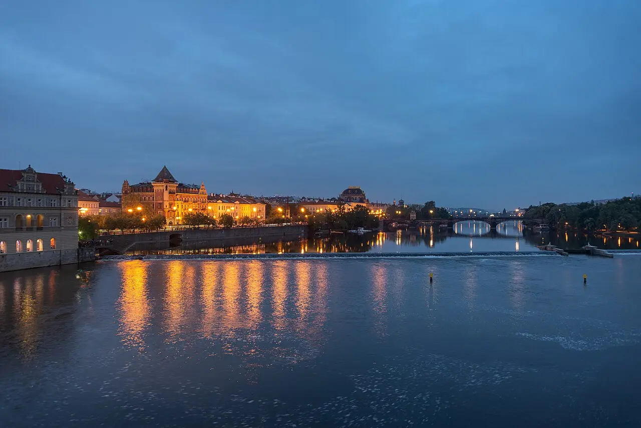 Prague Castle lit up over the Vltava