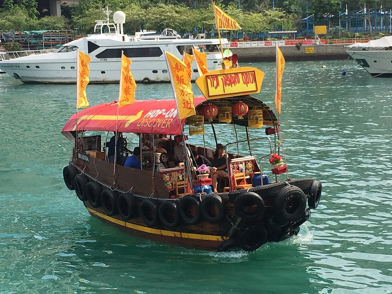 A decorated sampan cruising Aberdeen typhoon shelter