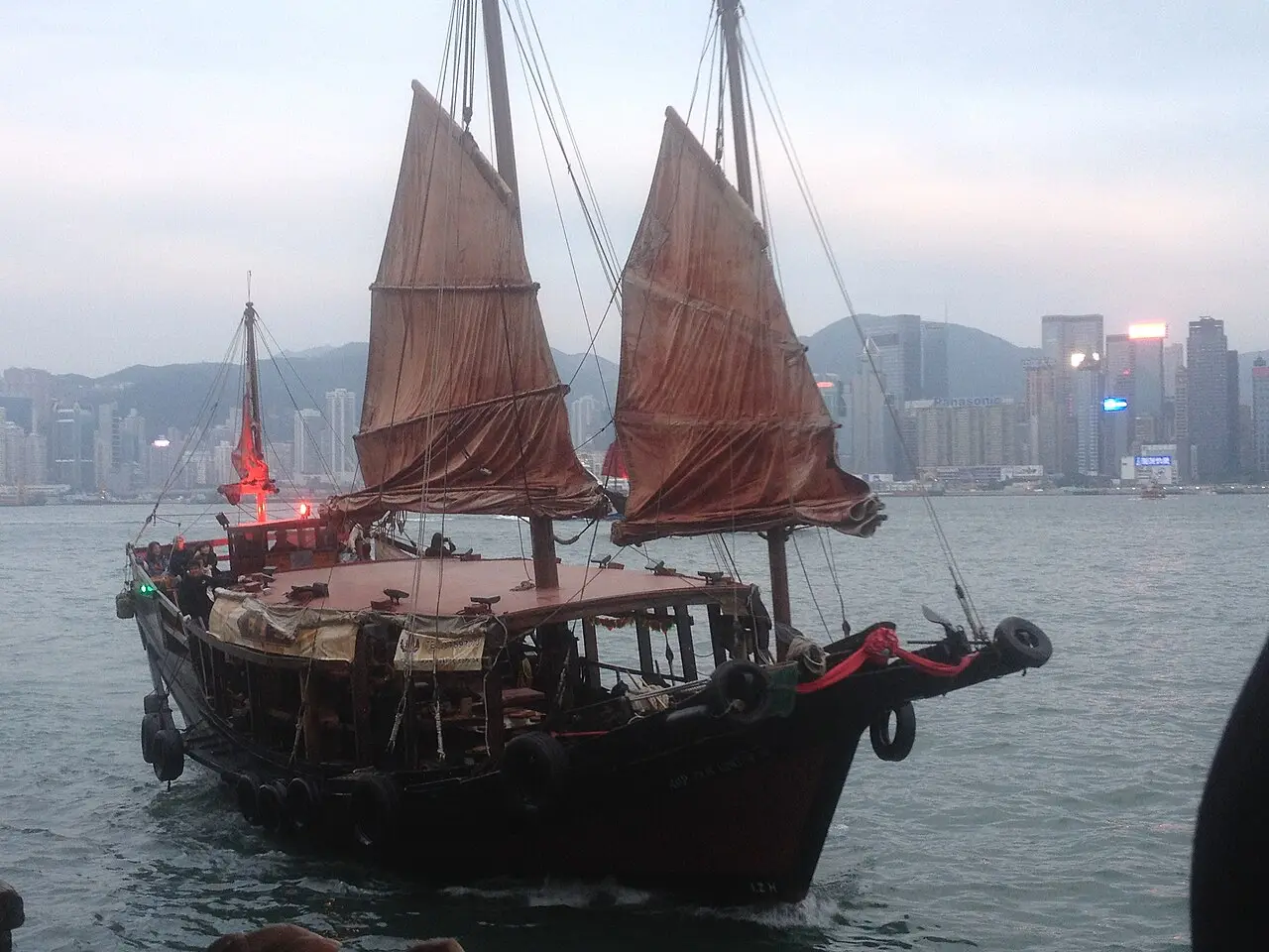 The Duk Ling junk sailing in front of the skyline