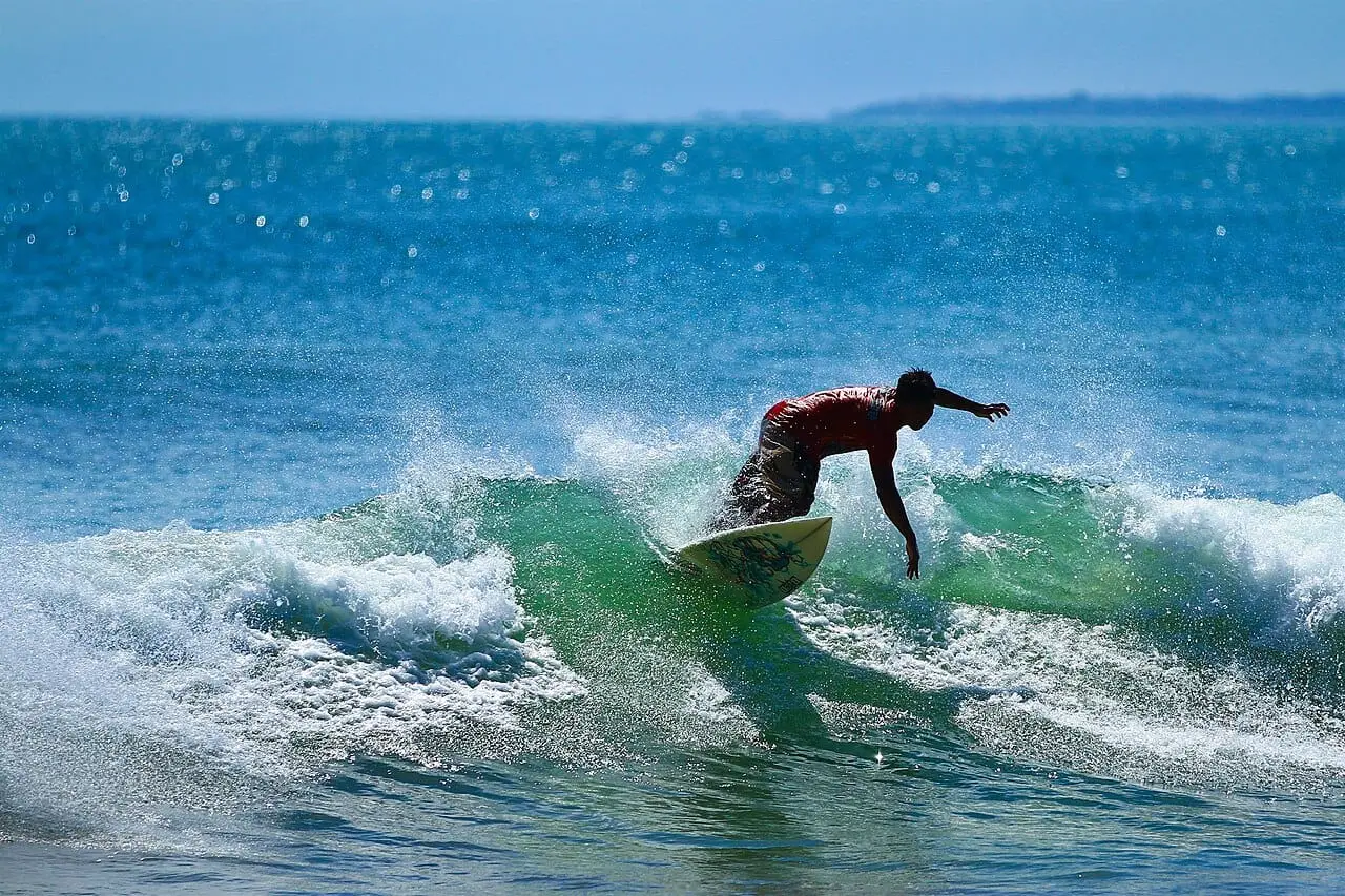 A surfer riding a wave off Kuta