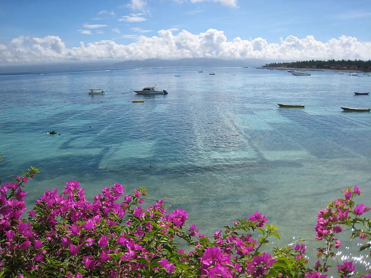 Clear shallow water and boats off Nusa Lembongan