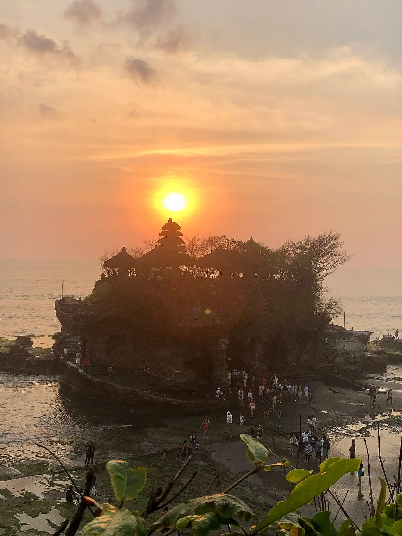 Tanah Lot temple silhouetted against the setting sun
