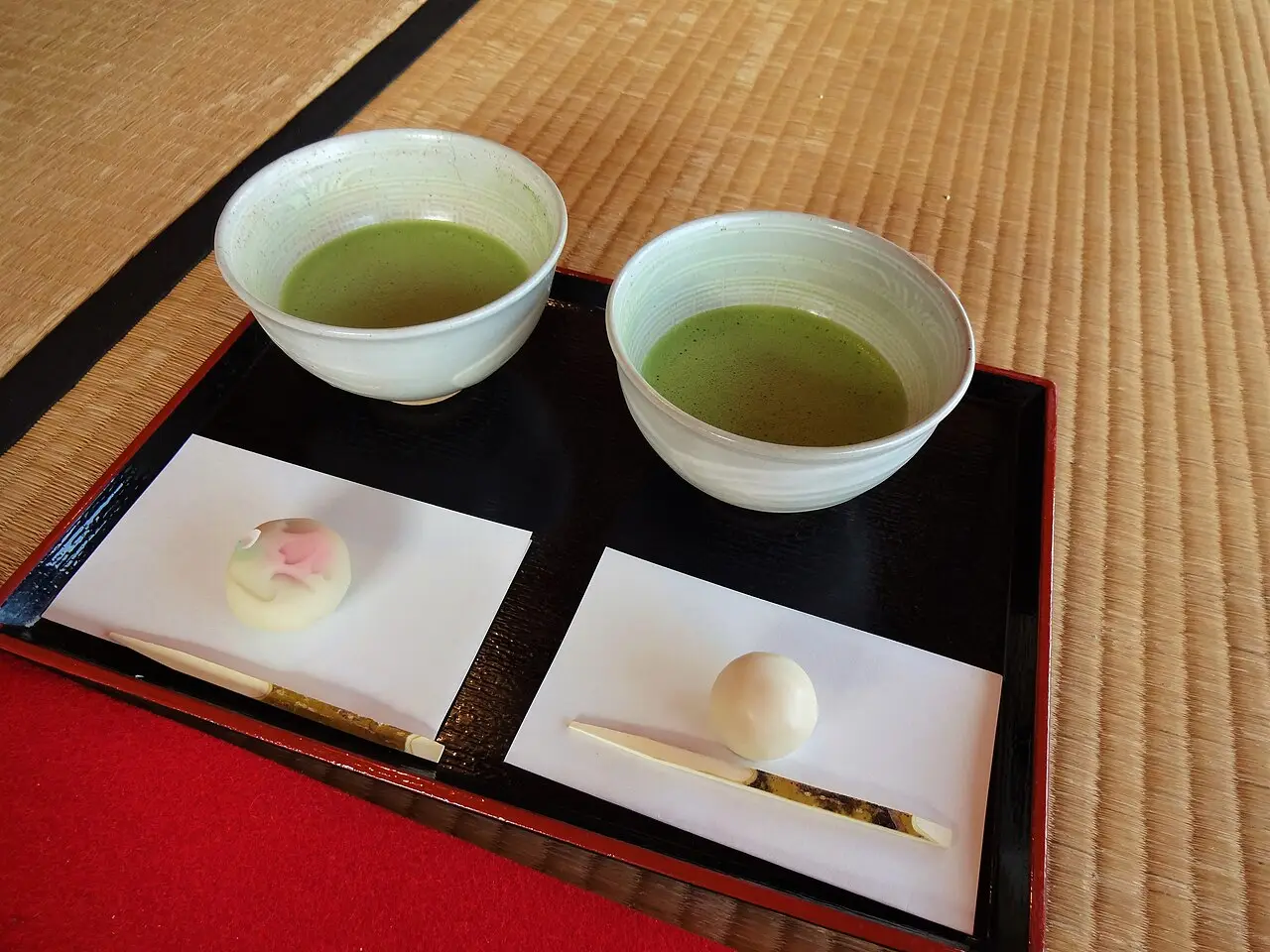 Two bowls of matcha with Japanese sweets on a tray