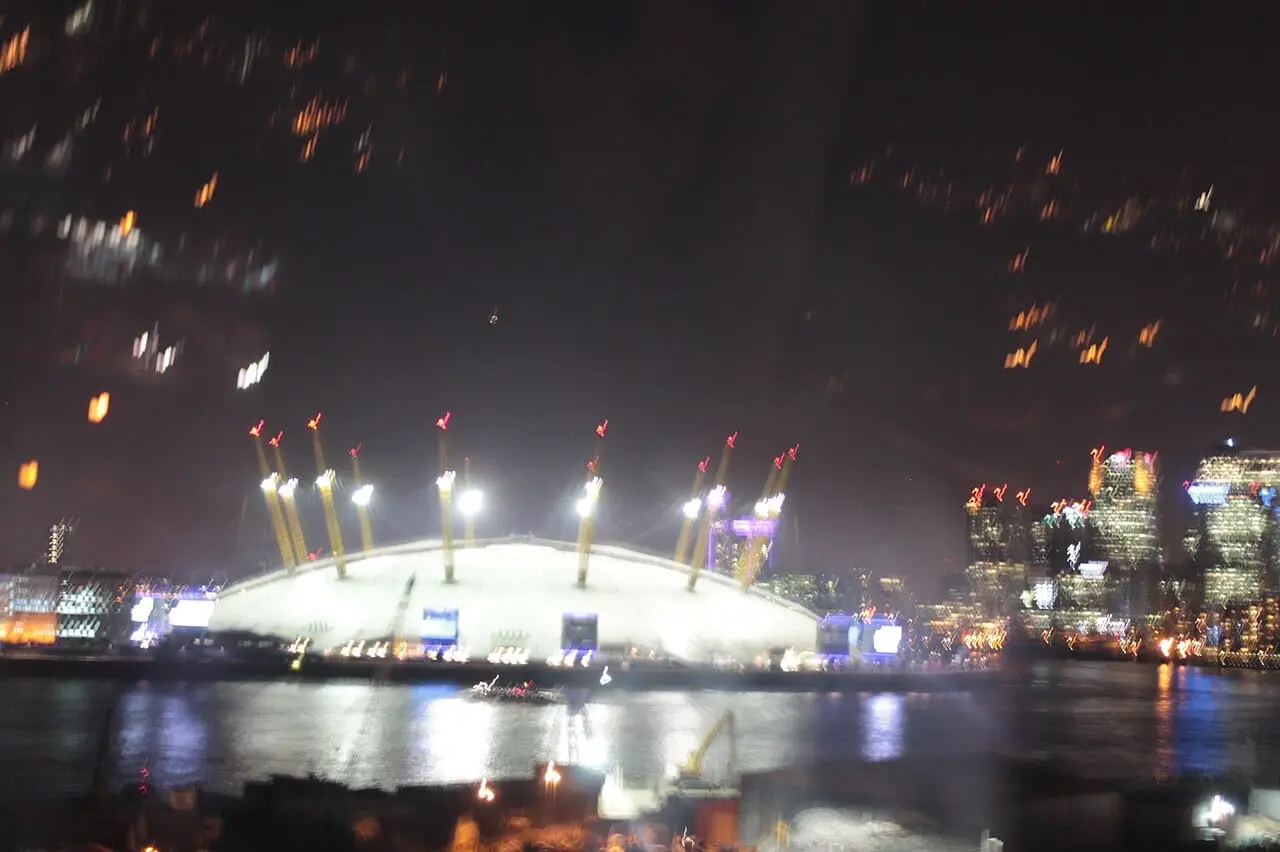 The O2 lit up at night across the Thames