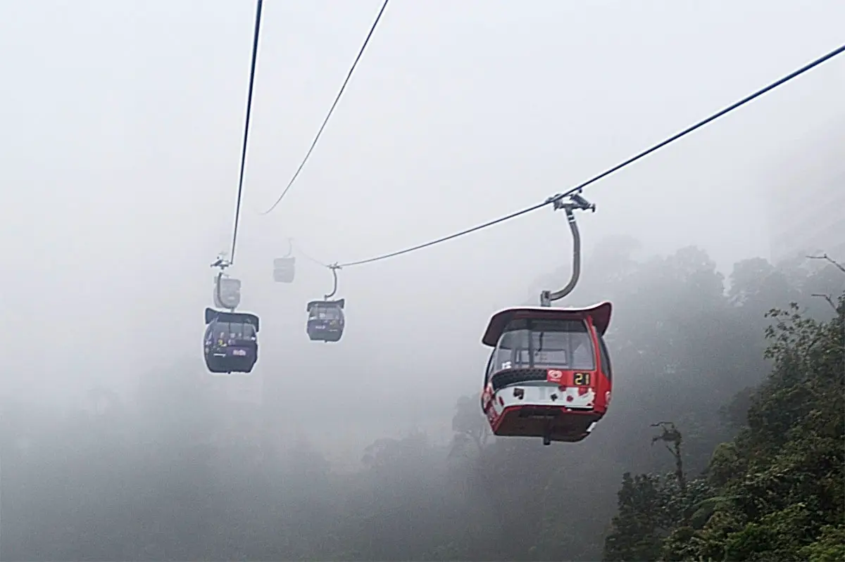 Cable cars gliding through the mountain mist