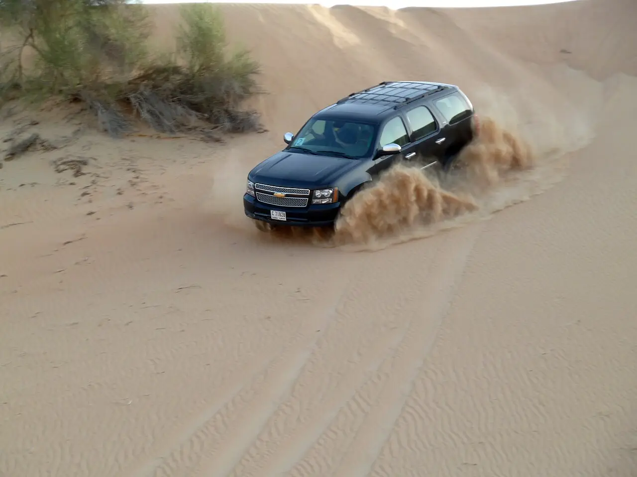 A 4x4 kicking up sand in the Dubai desert
