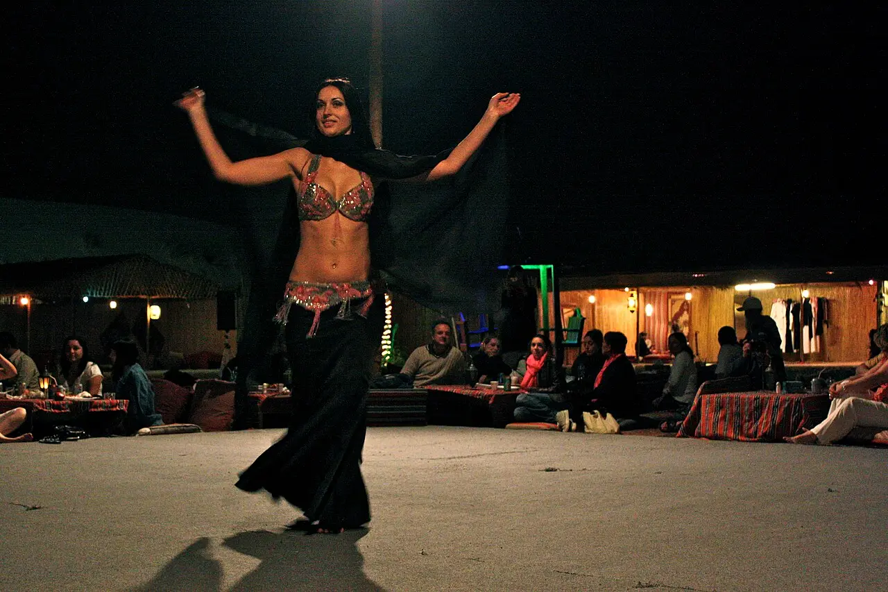A belly dance show at a desert camp