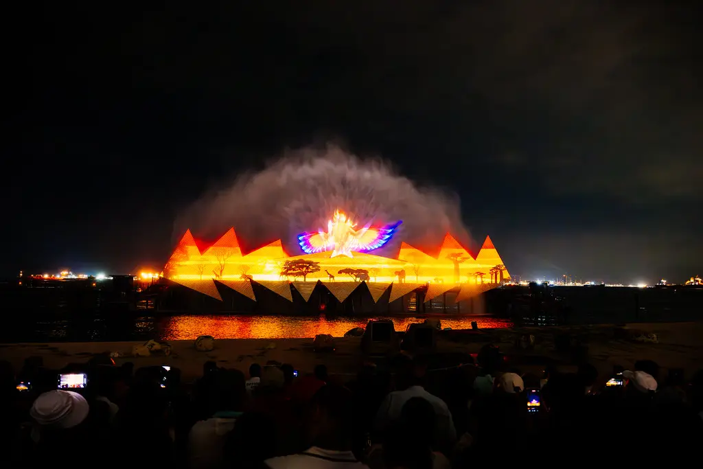 The Wings of Time show lit up over the sea