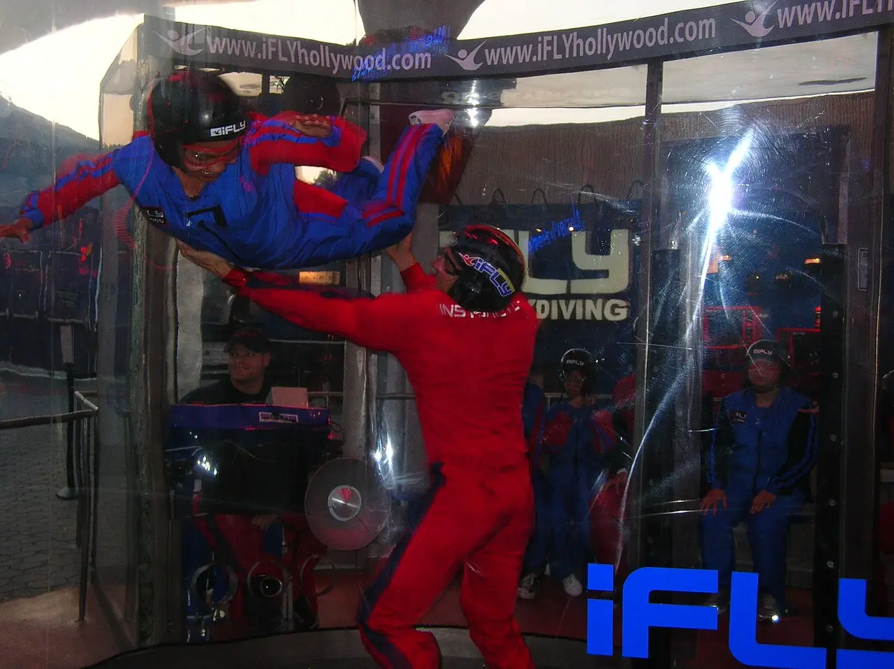 A first-time flyer floating in the wind tunnel with an instructor