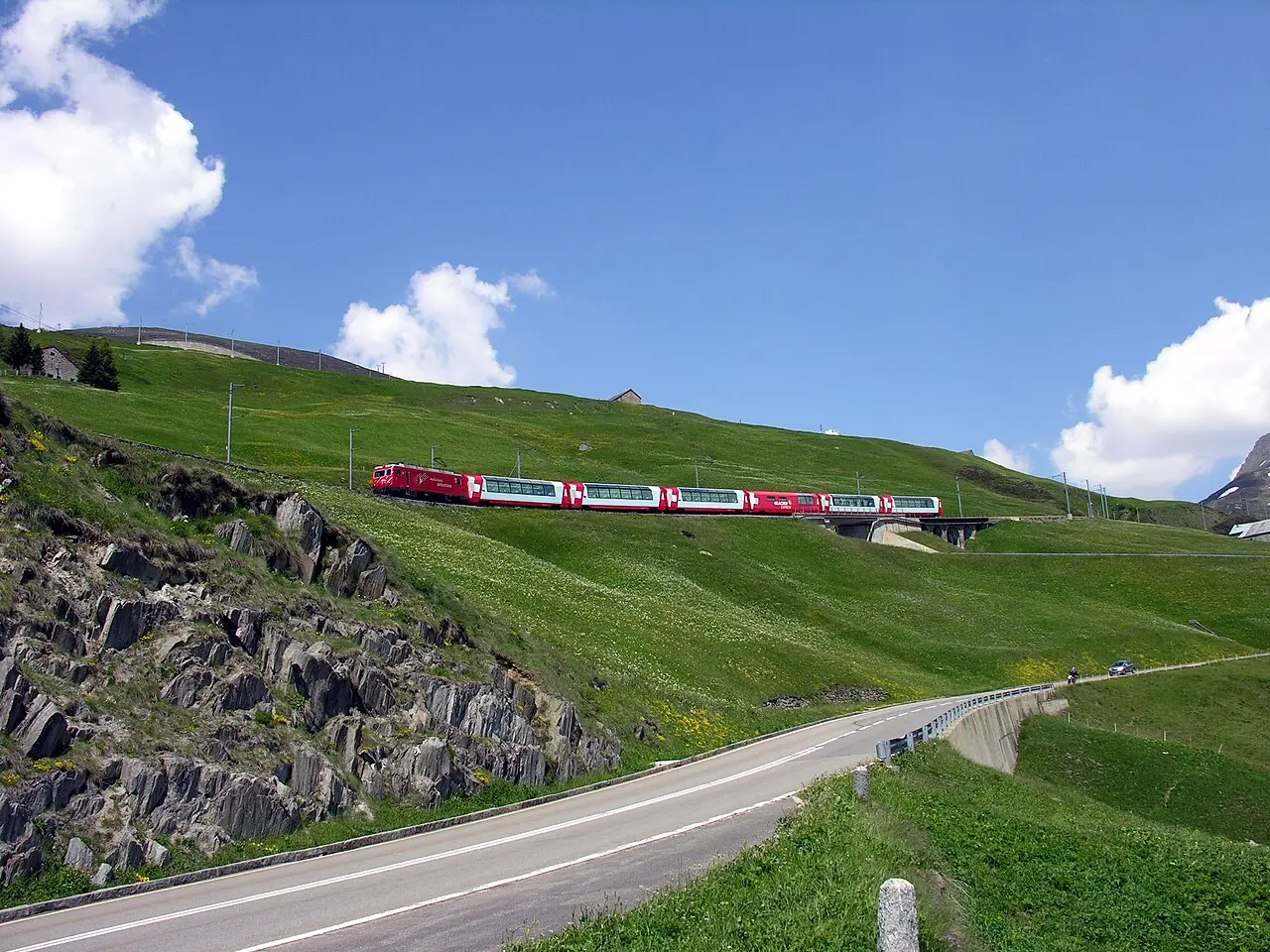 The Glacier Express crossing green pastures