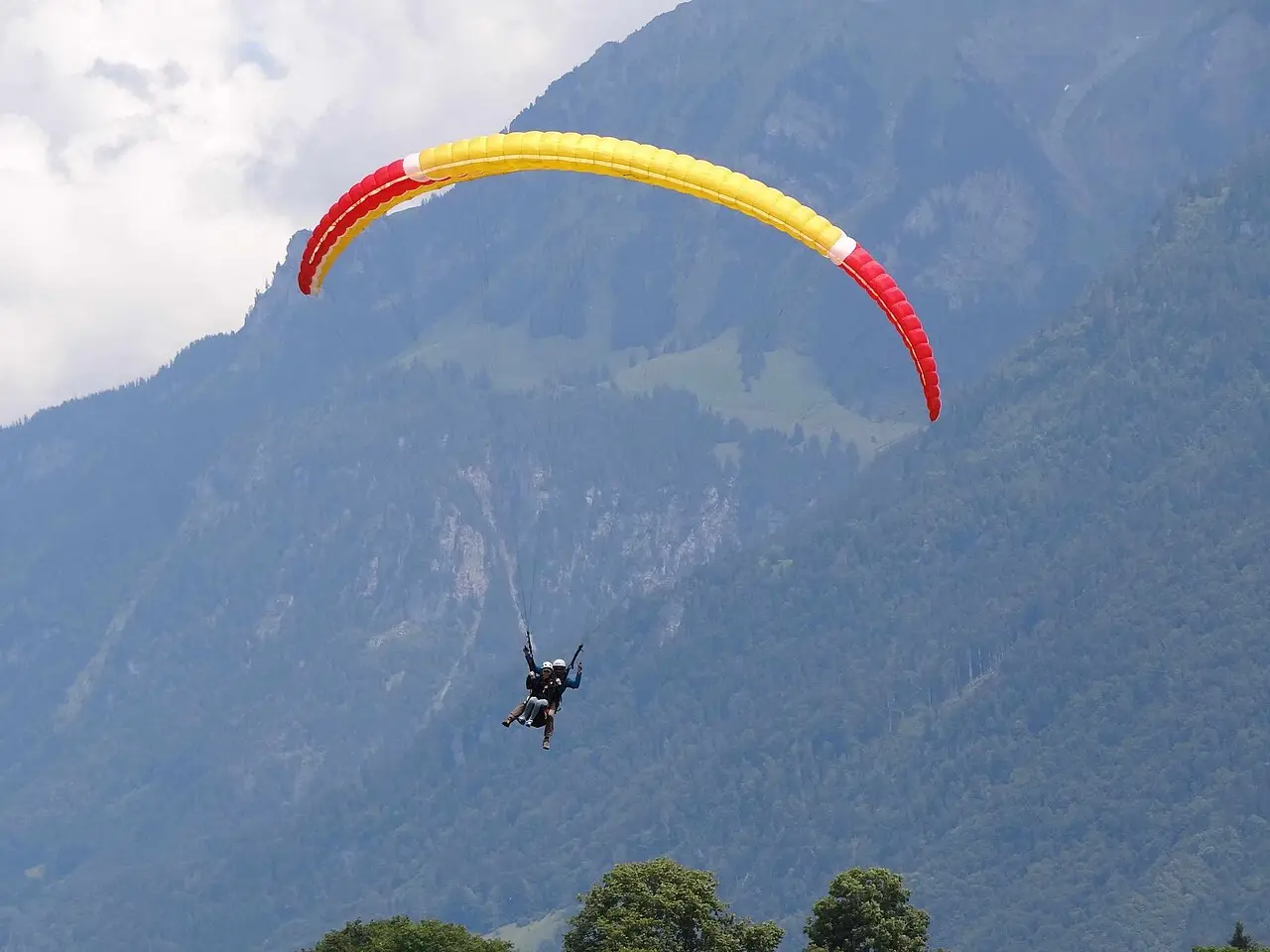 A tandem paraglider over the mountains near Interlaken