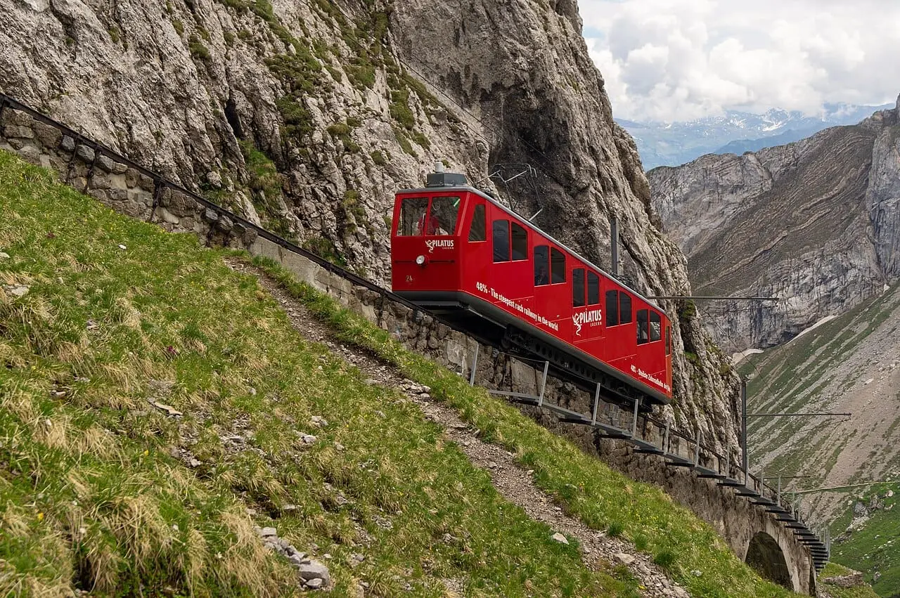 The red Pilatus cogwheel train on the steep slope