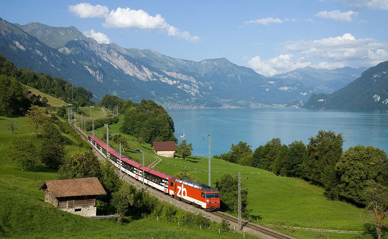 A Swiss train running beside a lake