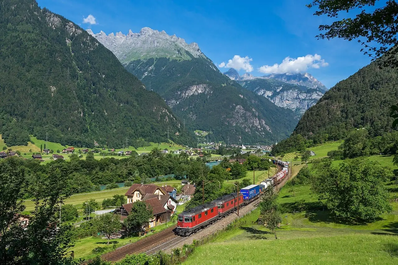 A train through a green alpine valley