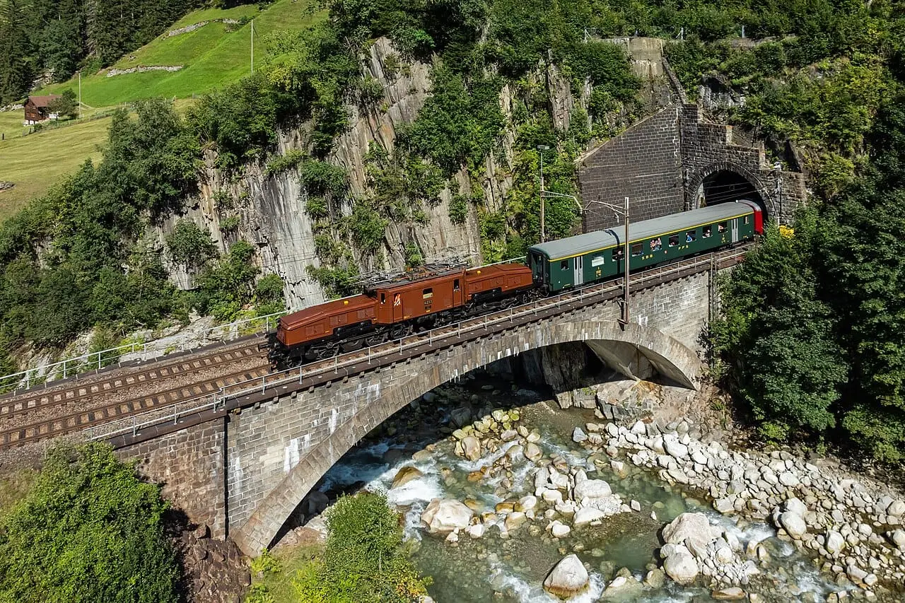 A train crossing a stone viaduct
