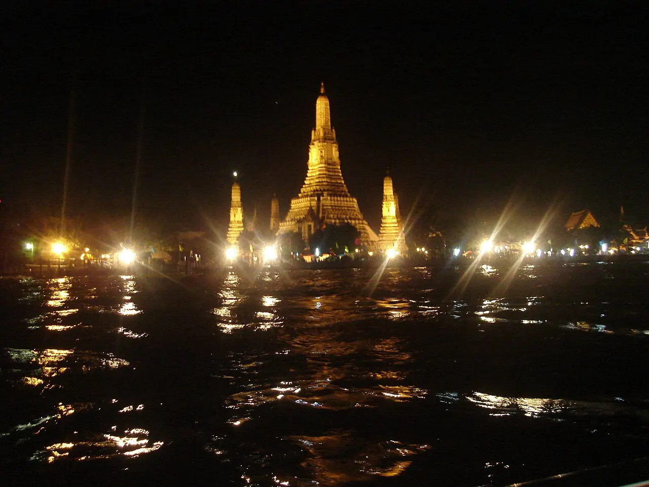 Wat Arun lit up at night on the bank of the Chao Phraya River
