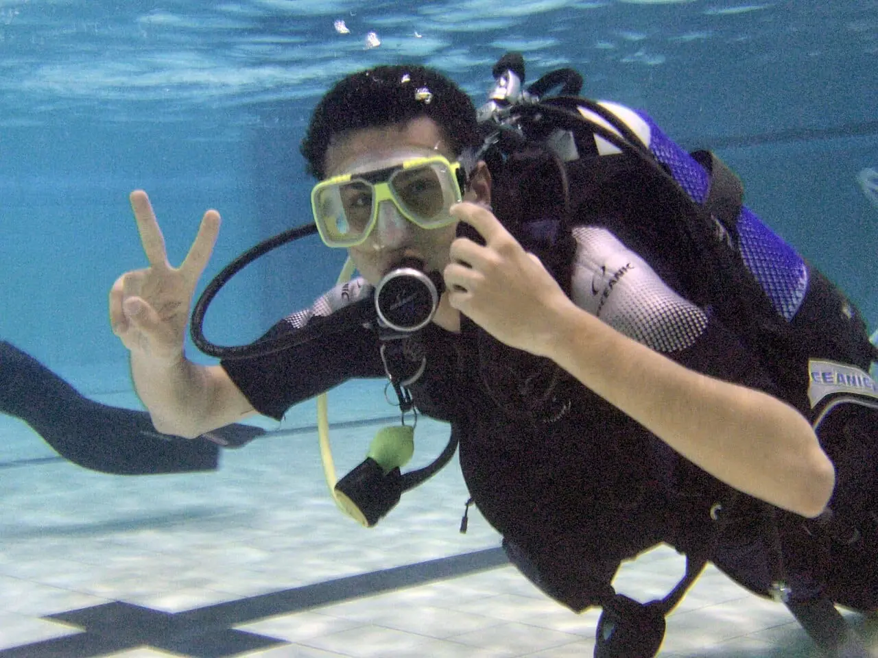 A scuba diver giving the OK sign