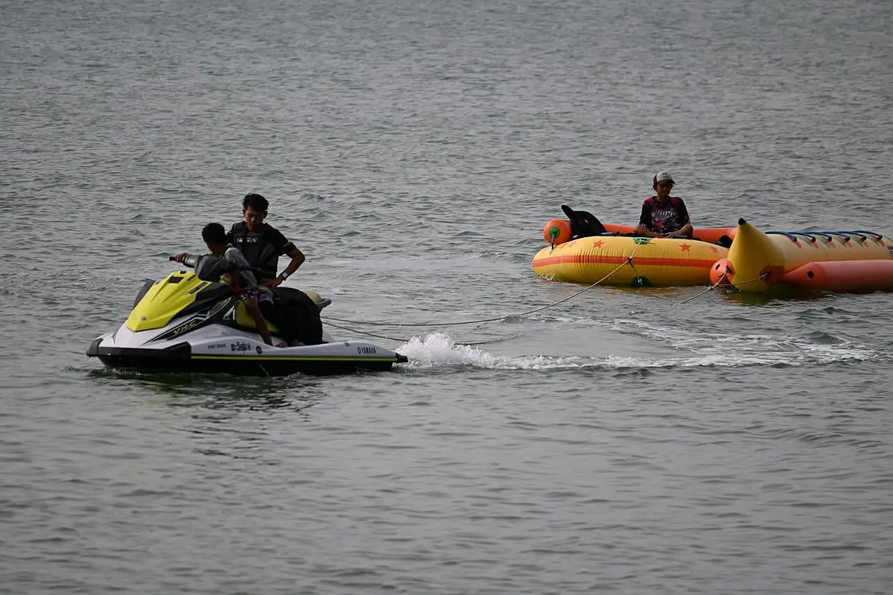 A jet ski towing an inflatable ride