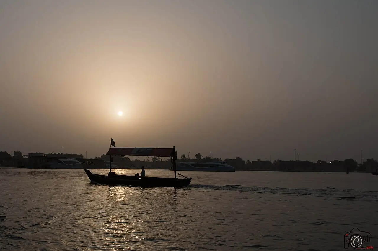 A small boat on the creek at sunset