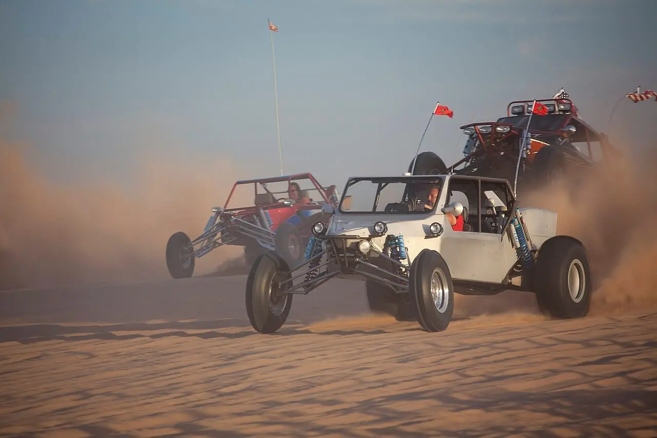Dune buggies racing across the sand