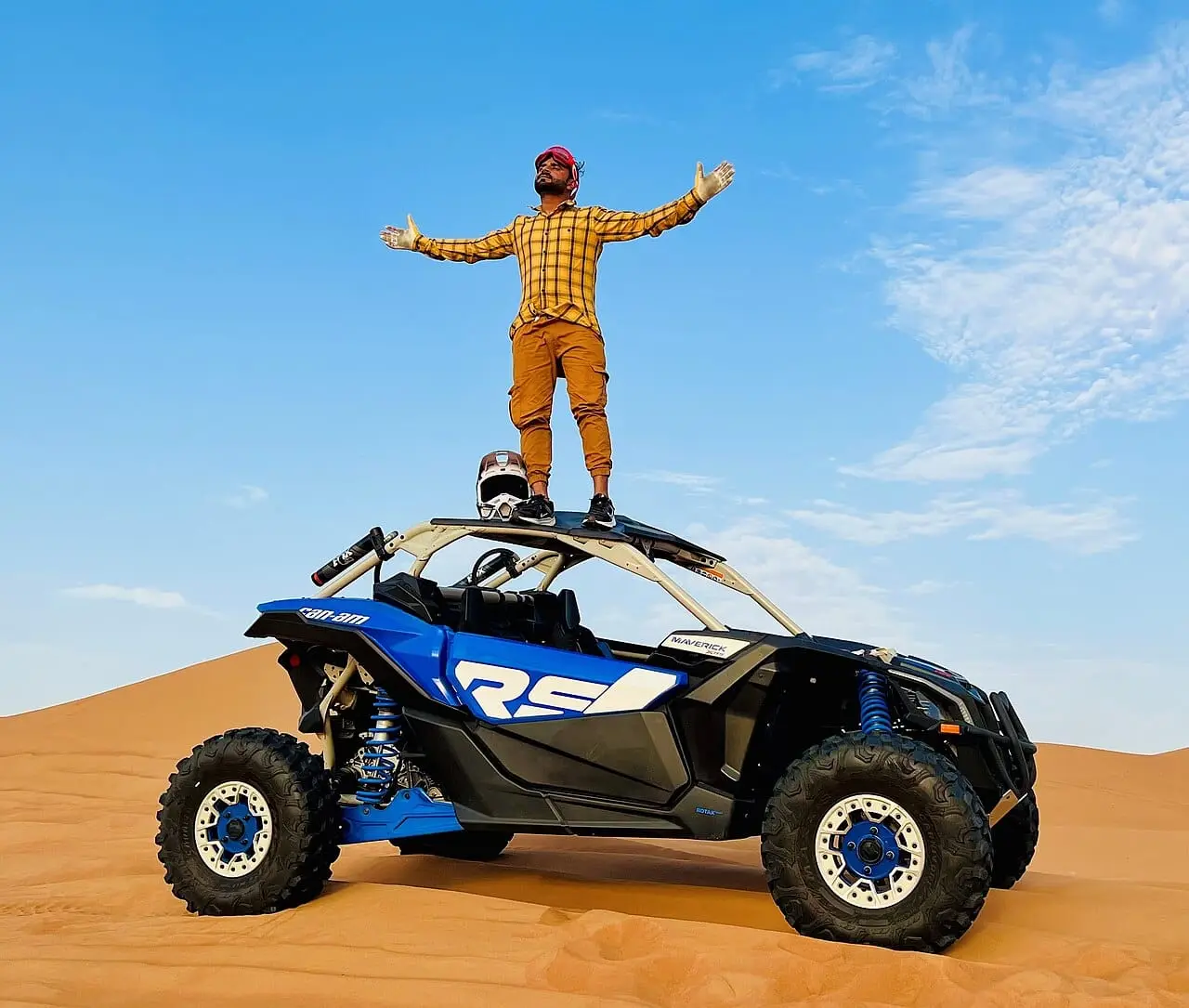 A buggy on top of a dune