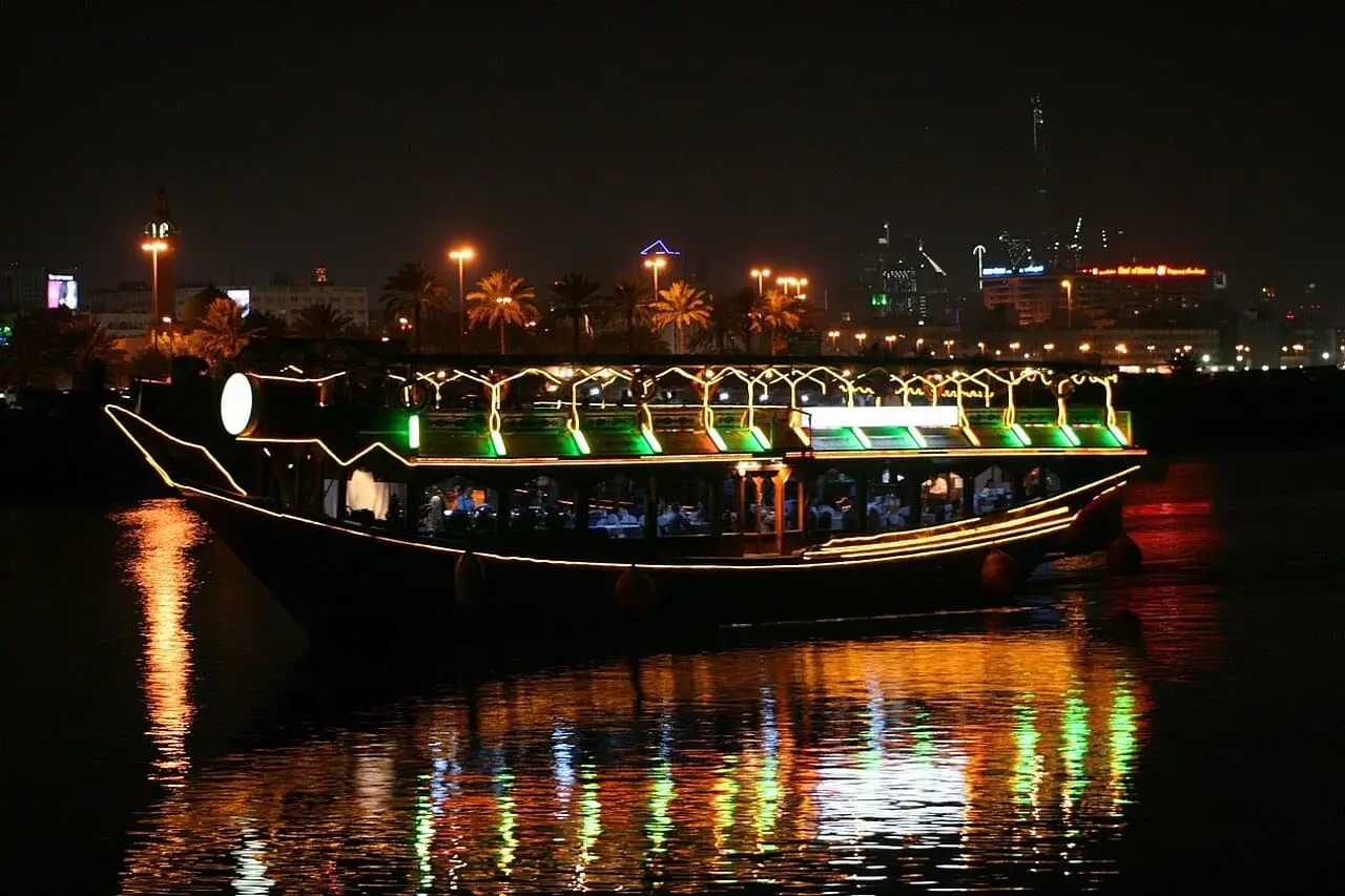 A lit-up dhow on Dubai Creek at night
