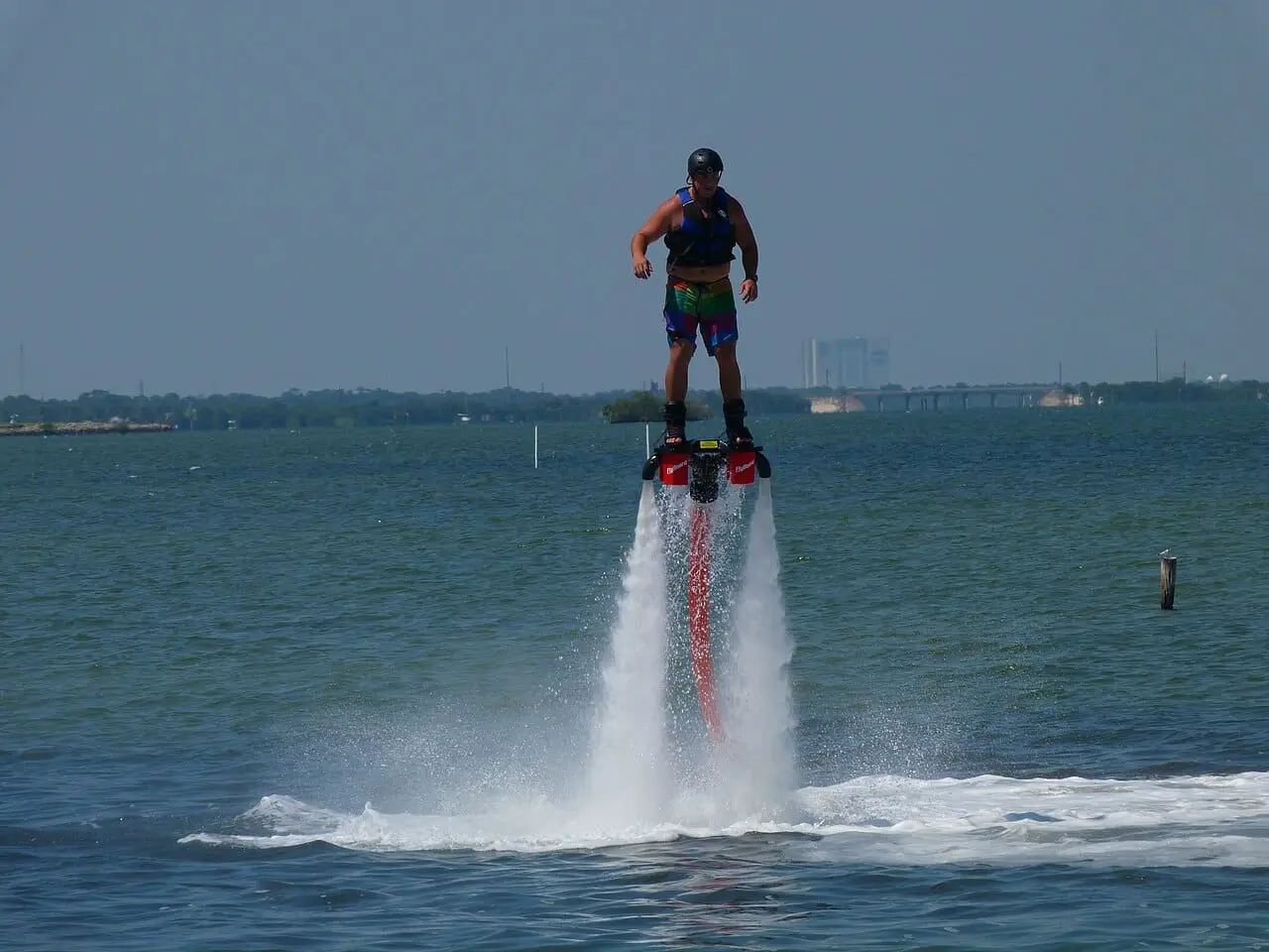 A flyboarder rising above the sea