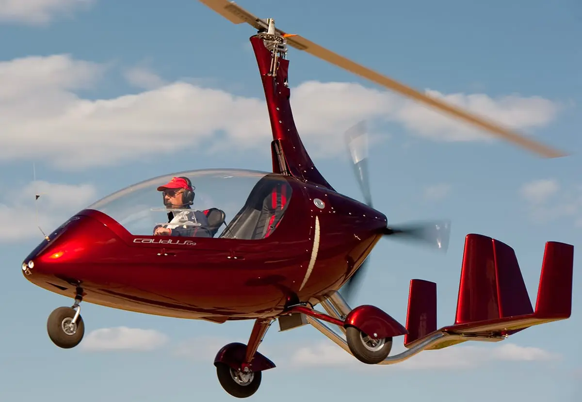 A two-seat gyrocopter taking off