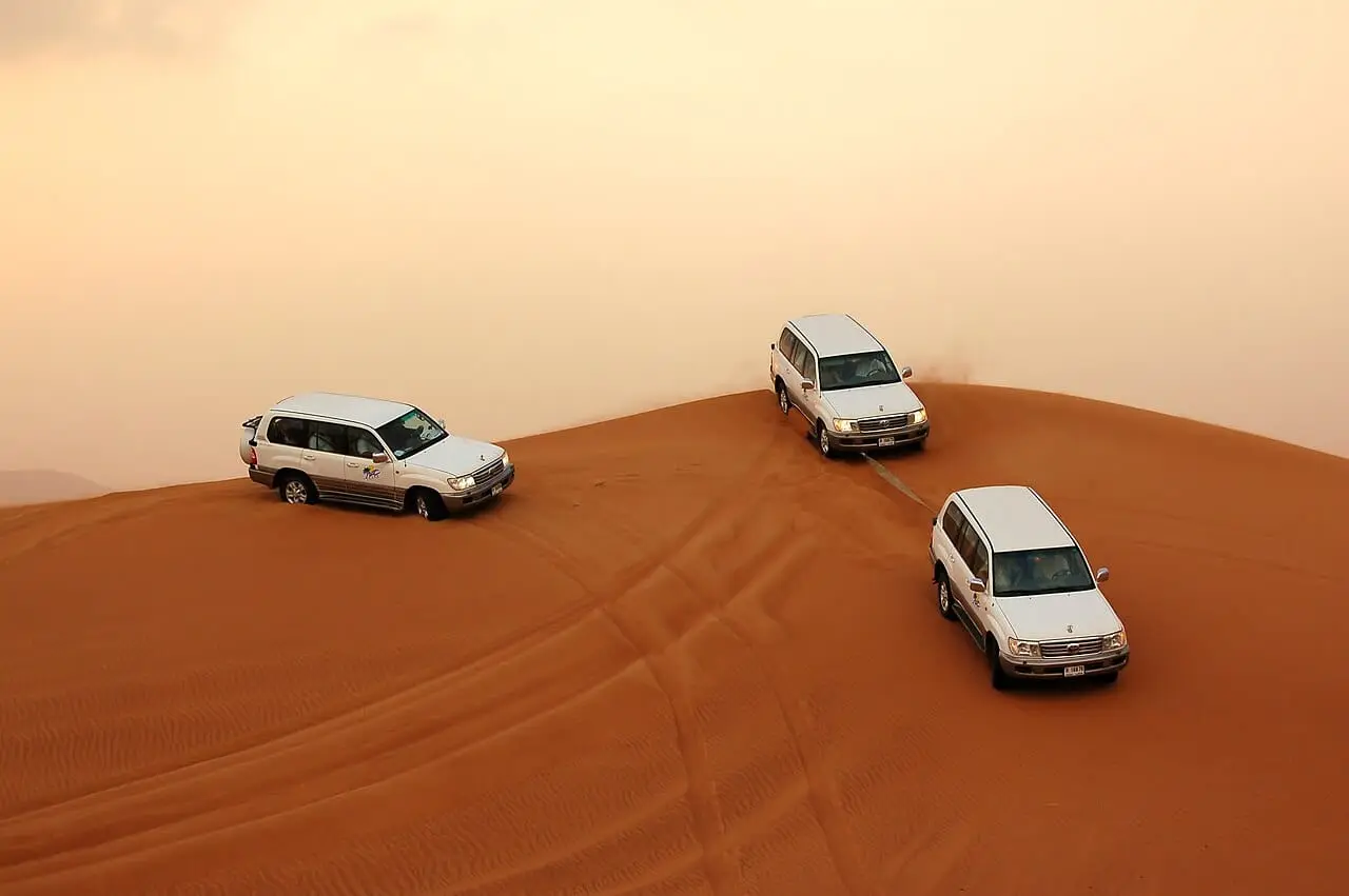 4x4s crossing the dunes on a desert safari