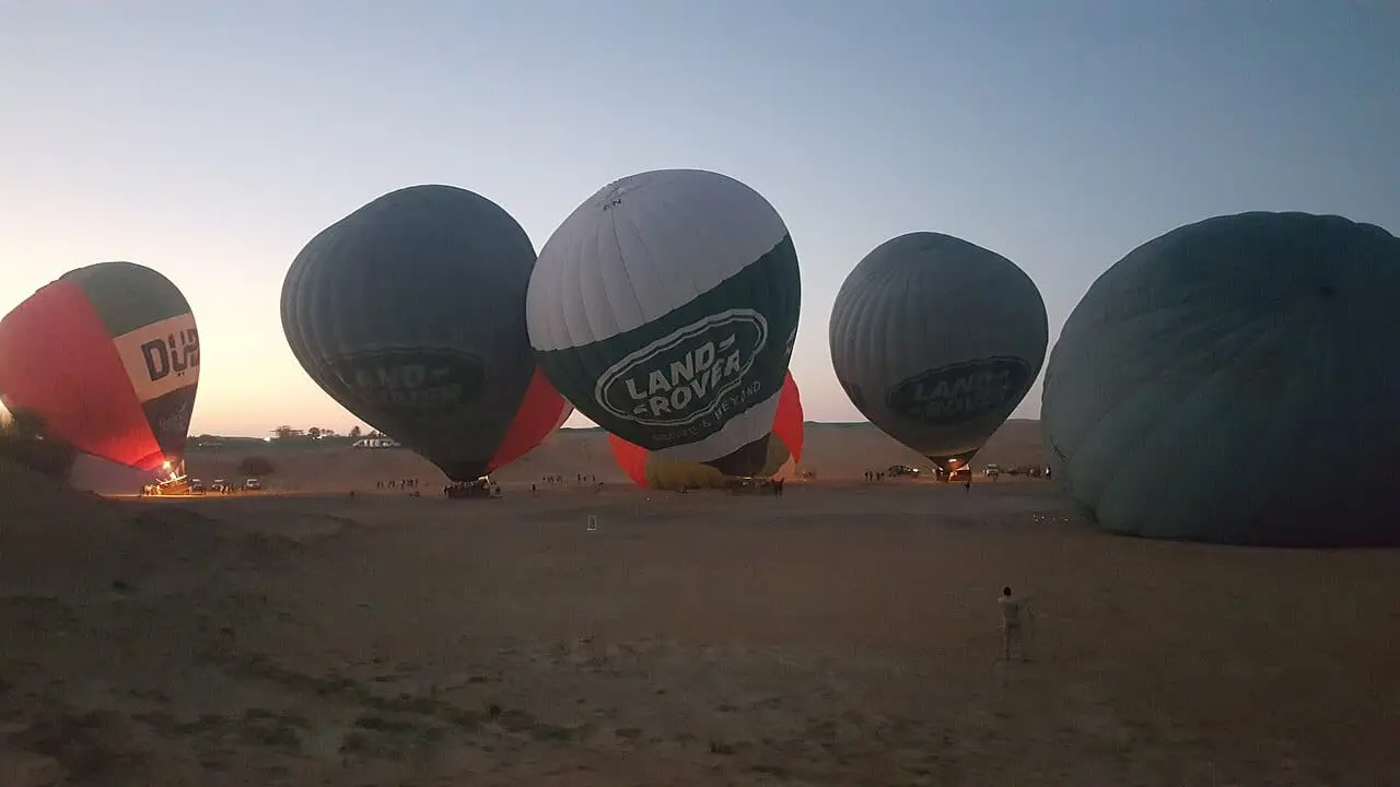 Balloons being inflated in the desert before dawn