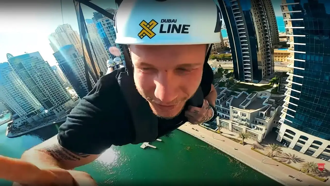A rider on the XLine zipline over Dubai Marina