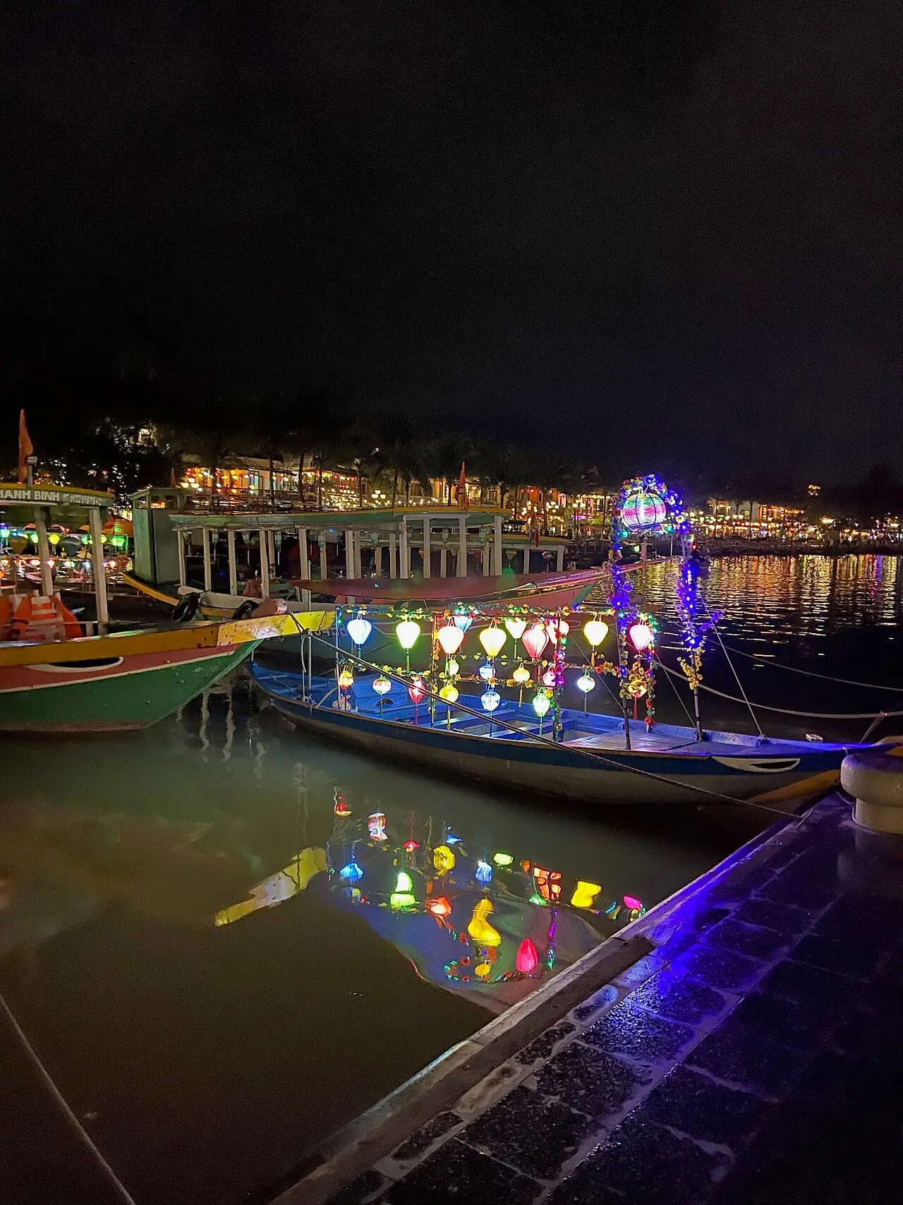Lantern-lit boats on the Thu Bon River in Hoi An at night