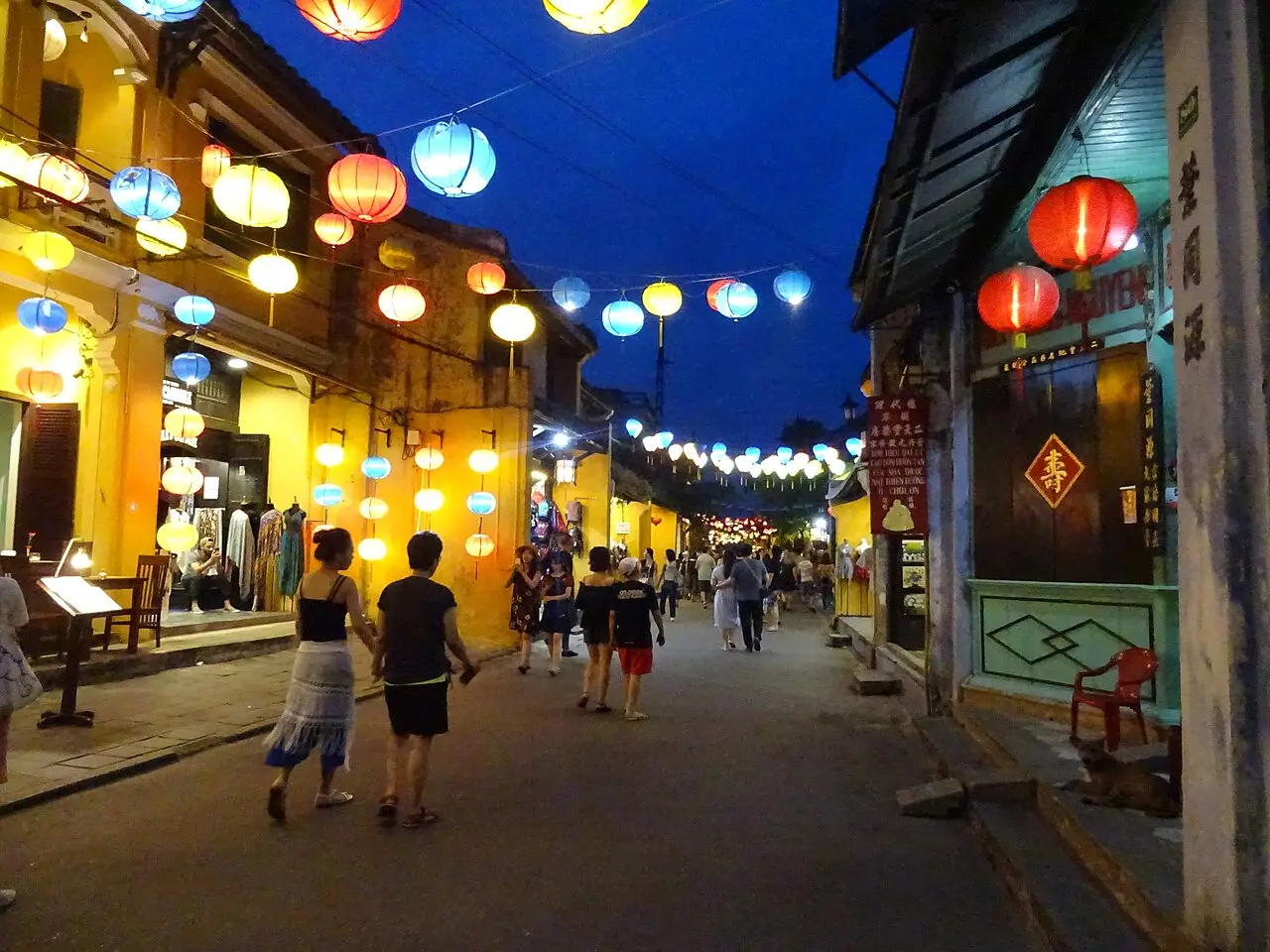Lanterns strung over an old-town street at night