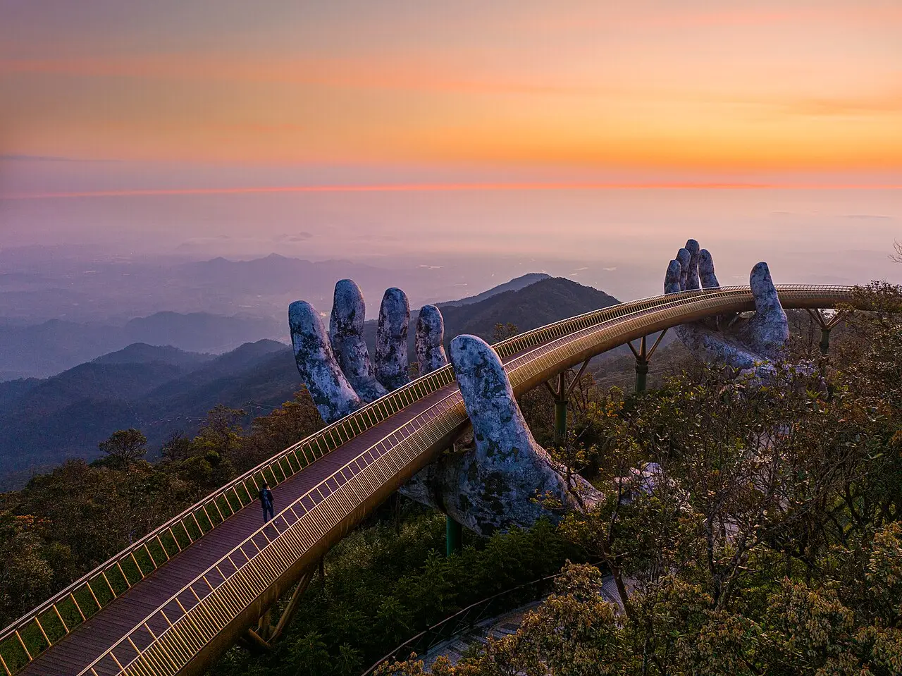 The Golden Bridge at sunset over the mountains