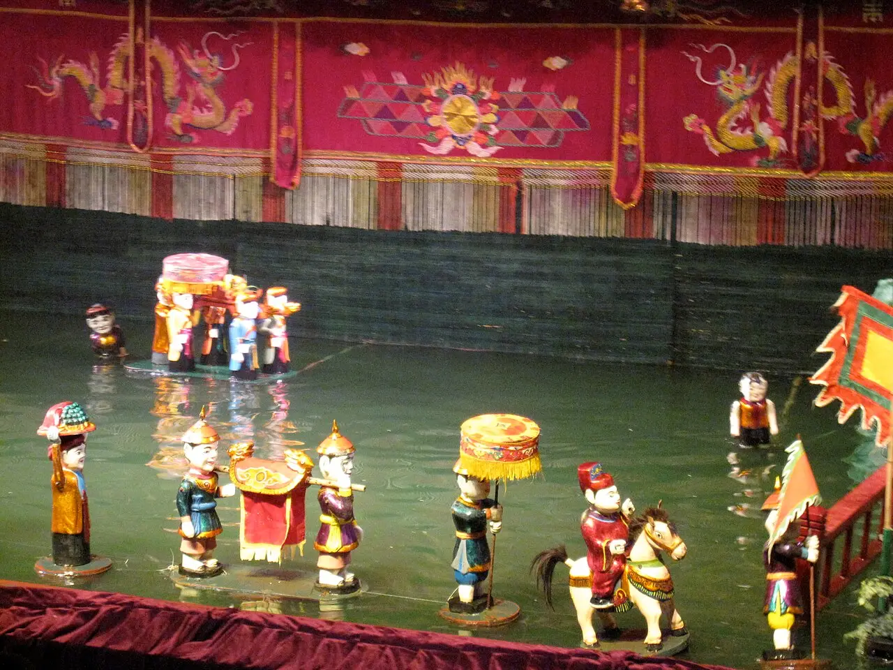 Water puppets performing on the pool stage at the Thang Long theatre
