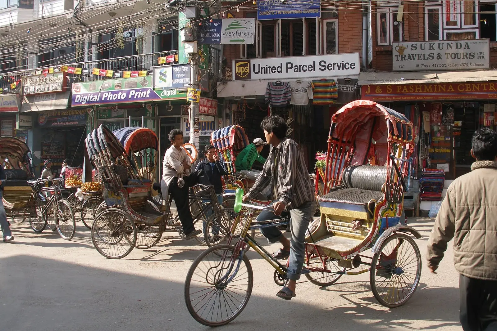 Cycle rickshaws and shops on a Thamel street
