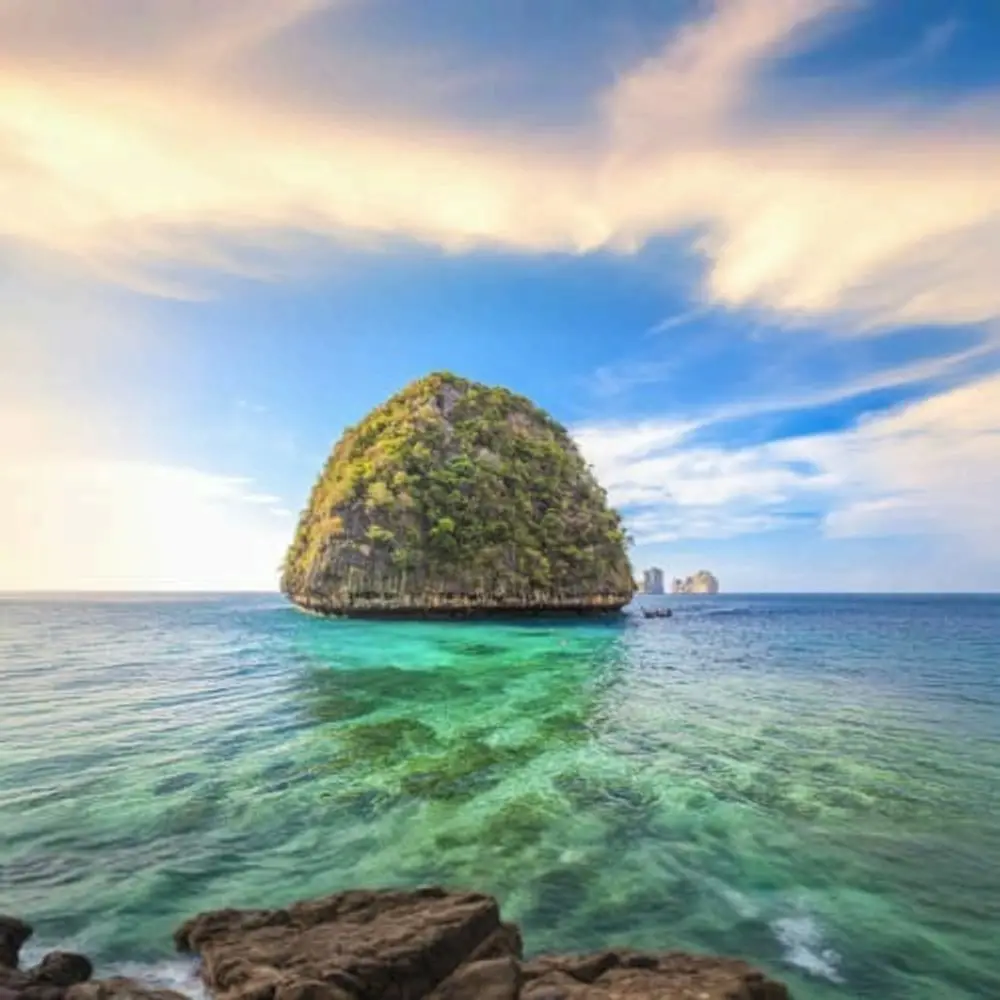 A limestone island rising from clear green water off Phuket