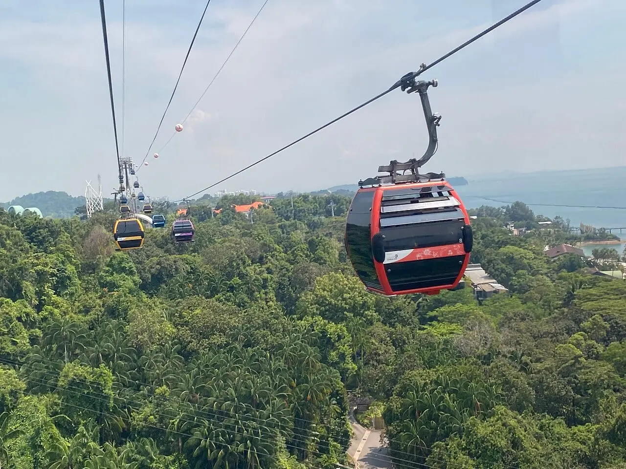 A Singapore Cable Car cabin above the treetops on Sentosa