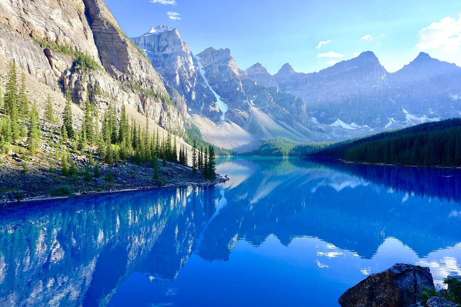 The turquoise water of Moraine Lake below snowy peaks in Banff National Park